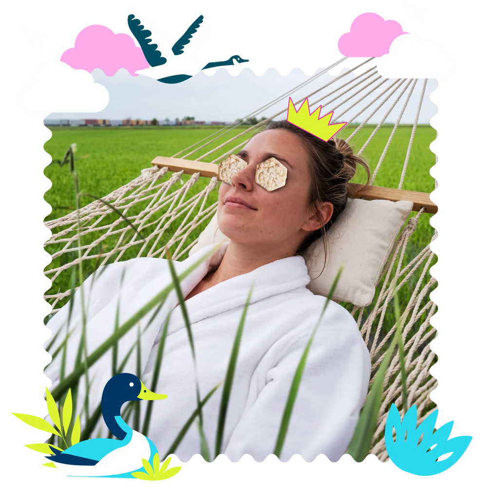 Young woman lounging in white robe with rice crackers over her eyes and illustrations around her